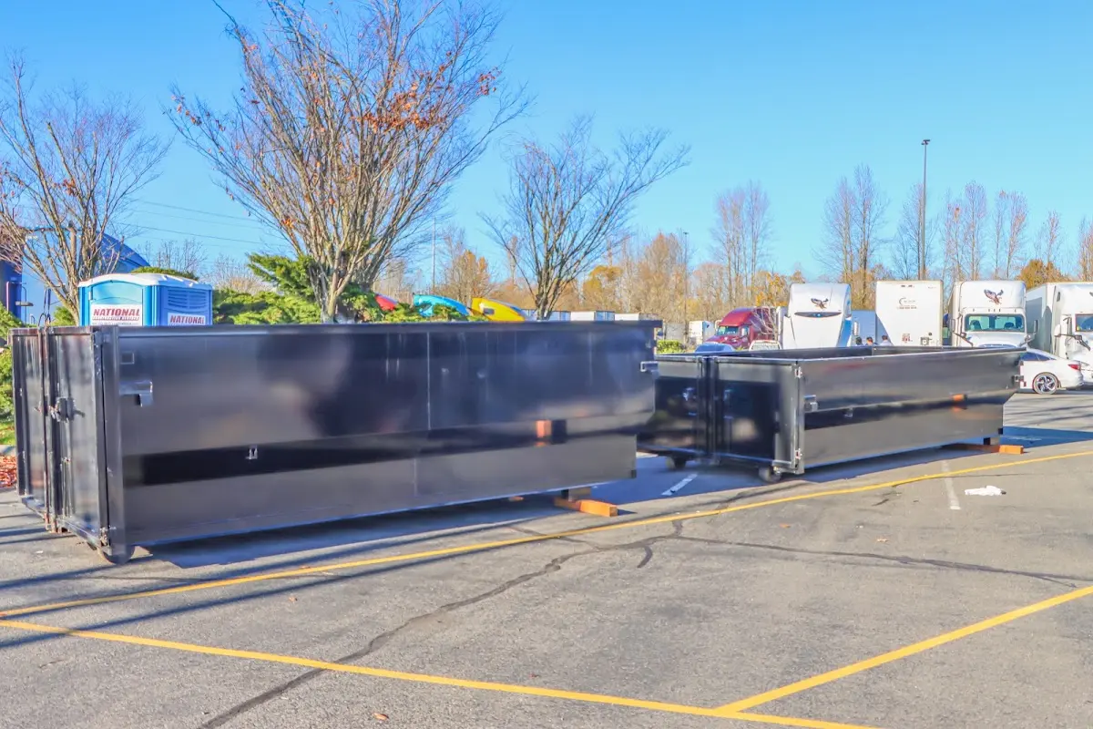 Professional dumpster rental service with roll-off container on residential driveway in Edwardsville